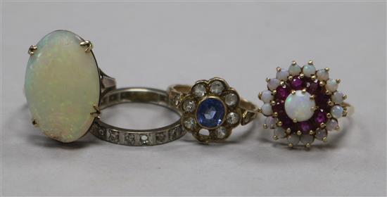 Three 9ct gold gem set rings including white opal, together with a diamond eternity ring (1 stone missing).